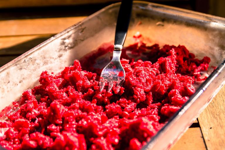 Raspberry Granita frozen raspberry being mashed and broken up