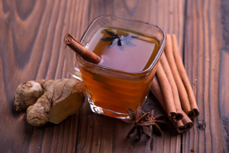 Spiced Cranberry-Apple Cider a mug of apple cranberry cider with cinnamon, star anise, and ginger