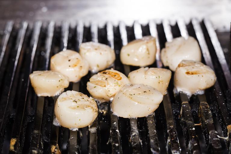 Grilled Scallops with Asparagus Salad scallops cooking on a grill