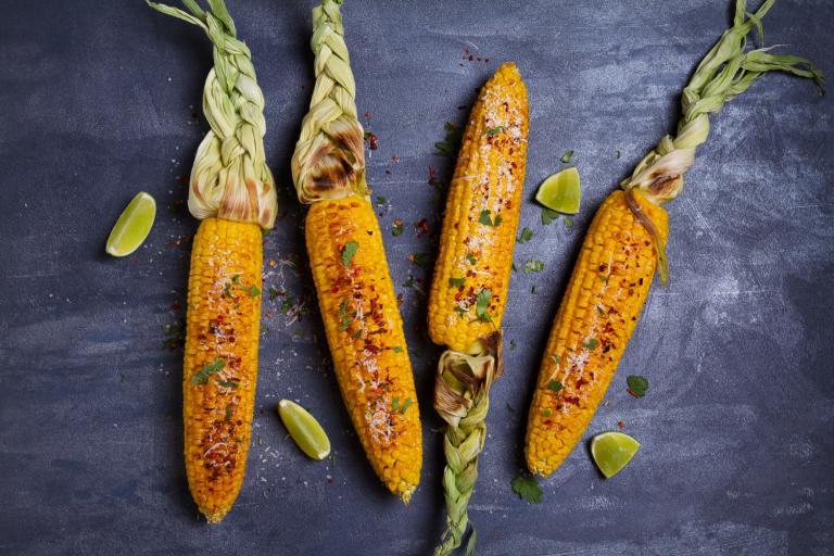 Grilled Corn on the Cob ears of grilled corn with lime, paprika, and cheese