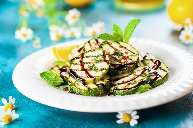 Grilled Vegetables with Balsamic Glaze a plate of grilled zucchini drizzled in balsamic