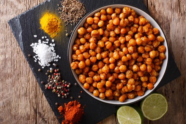 Spicy Roasted Chickpeas a bowl of roasted chickpeas and the spices used making them