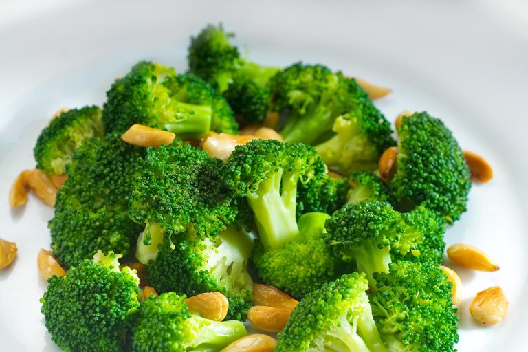 Warm Broccoli Salad with Maple-Dijon Dressing a bowl of broccoli and chopped nuts