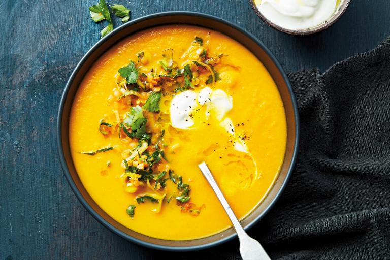 Carrot Soup with Orange-Marinated Lentils a garnished bowl of carrot soup