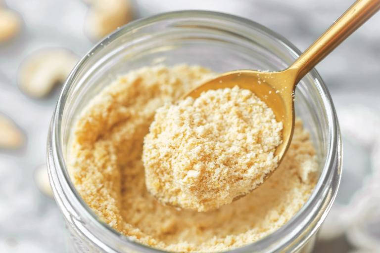 4-Ingredient Vegan Parmesan a jar of powdered vegan cheese