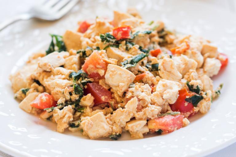 Italian Tofu Scramble a plate of scrambled tofu with greens and tomatoes